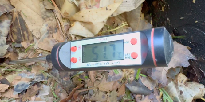 Thermometer reading the temperature of compost inside Bioverter