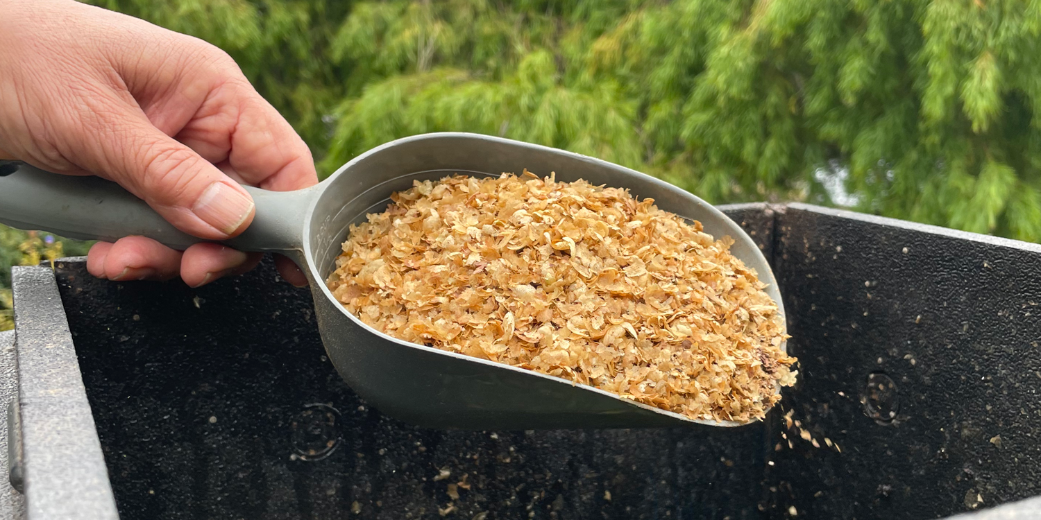 Scoop containing coffee chaff
